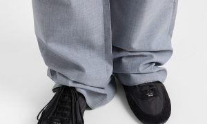 model wearing gray pants and black sneakers