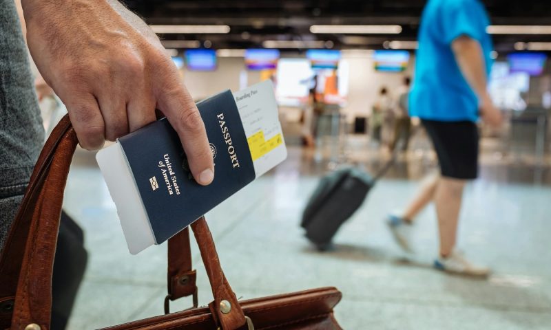 Man holding a passport in his hand at the airport