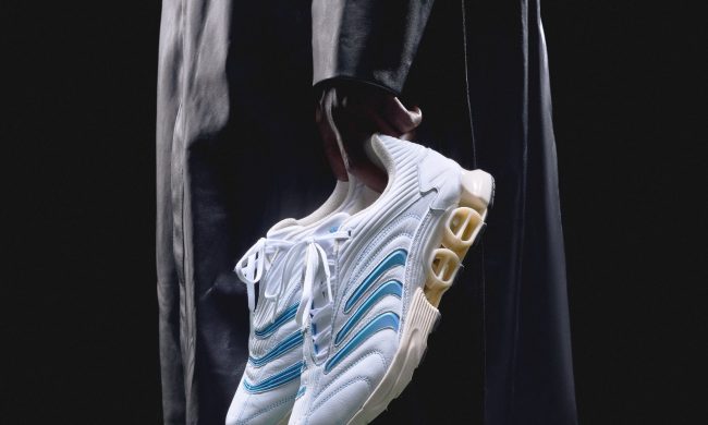 man holding adidas x kith sneaker