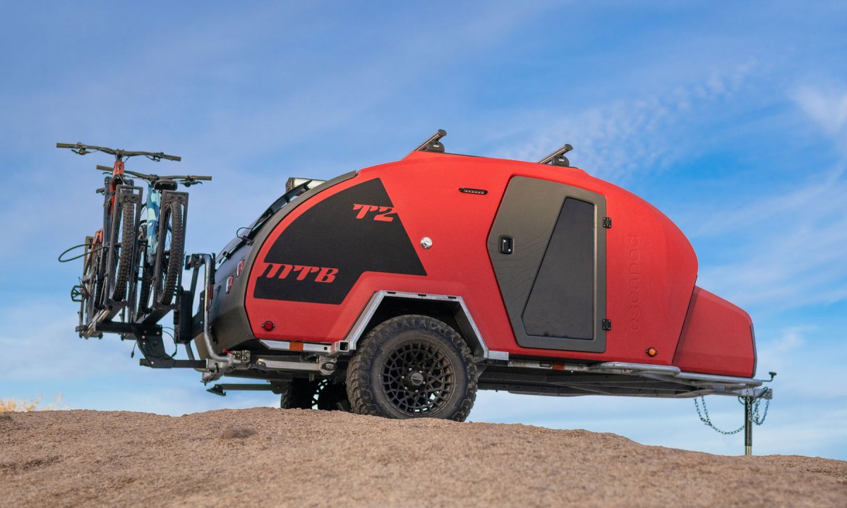 An Escapod TOPO2 MTB mountain biking towable camper parked in the desert.